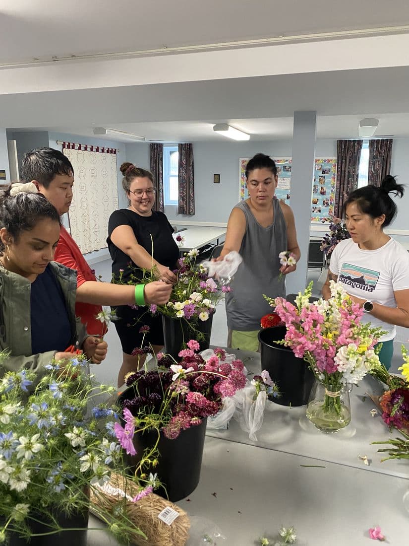 A bouquet workshop, friends arranging stems straight from the buckets